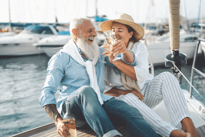 Mature couple drinking wine on yacht