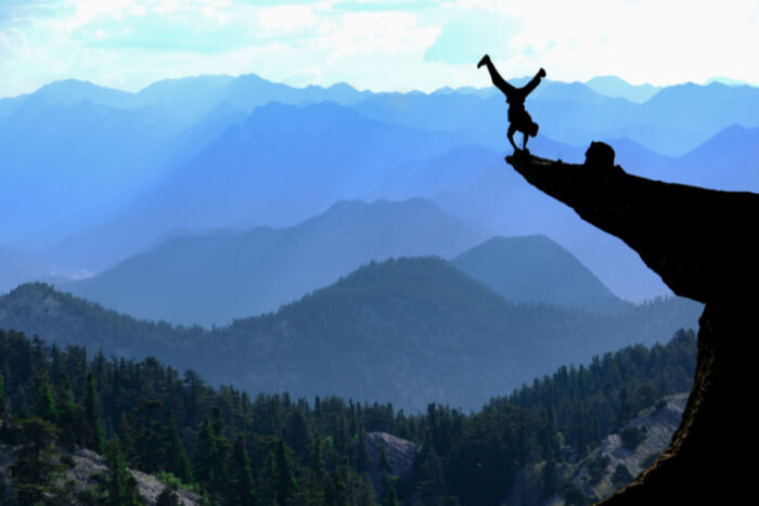 Man balancing on cliff edge